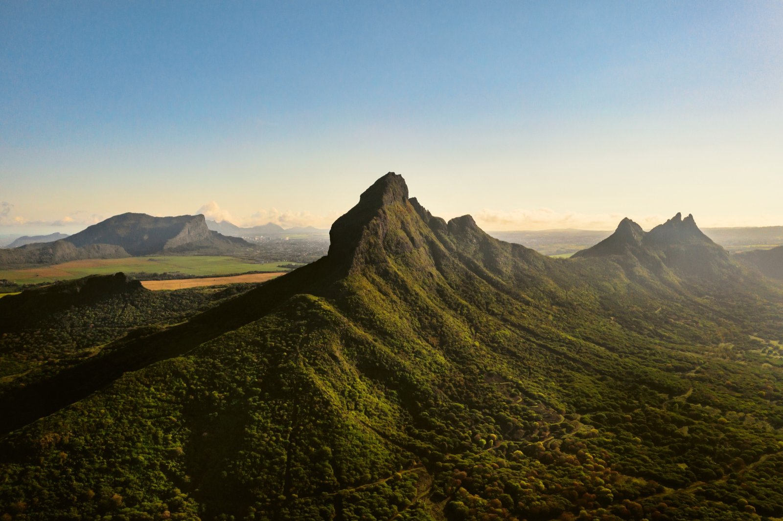 Aerial view of mountains and fields across an emerging market landscape